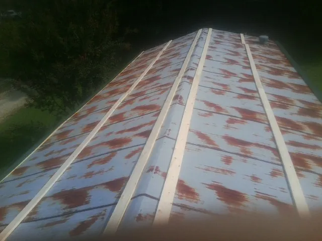 Rusted metal roof panels with new wood purlins before replacement — Storm Damage Roof Repair in Glen Wild by Roofing Brothers
